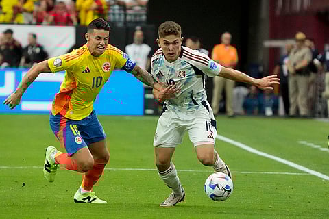 James Rodriguez and Brandon Aguilera battle for the ball